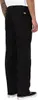 A person wearing black Dickies work pants, shown from the side. Produktbild-Vorschau