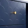 A close-up view of a navy blue dresser drawer with a scalloped pattern and a gold knob. Anteprima dell’immagine prodotto