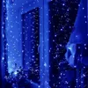 A window decorated with blue LED string lights, creating a festive atmosphere. Náhled obrázku produktu