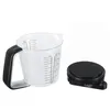 A clear plastic measuring cup and a black digital scale are shown against a white background. Náhľad obrázku produktu