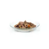 A close-up of wet dog food in a clear bowl. Produktbild-Vorschau