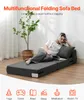 A woman is lying on a folded sofa bed, reading a book, with a plant in the background. Produktbild-Vorschau