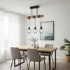 A dining room scene with a wooden table, chairs, and a pendant light fixture. Náhľad obrázku produktu