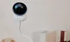 A white baby monitor camera is shown on a white surface against a white background. Anteprima dell’immagine prodotto