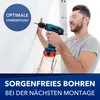 A man wearing safety glasses is using a cordless drill to drill into a white wall. There is a ladder in the background. Anteprima dell’immagine prodotto