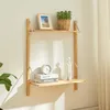 A wooden wall shelf with decorative items and books. Voir les images du produit