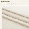 A close-up of folded beige fabric, likely velvet or a similar soft material, with text overlays. Produktbild-Vorschau