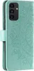 A teal colored phone case with a mandala pattern embossed on it. Produktbild-Vorschau