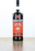 A bottle of Ramazzotti Amaro liqueur is displayed on a wooden surface against a white background. Produktbild-Vorschau