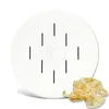 A white pasta maker disc with slots, and a pile of tagliatelle pasta to the side. Voir les images du produit