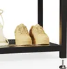A close-up view of a shelf with two beige sneakers and a white high-heeled shoe. Podgląd zdjęcia produktu