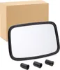 A product shot of a rectangular mirror with a black frame, placed in front of a cardboard box. Three black cylindrical accessories are positioned in the foreground. Anteprima dell’immagine prodotto
