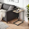 A side table is placed next to a sofa in a living room setting. Produktbild-Vorschau