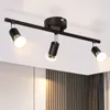 A black three-light track light fixture mounted on a white ceiling. Produktbild-Vorschau