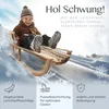 A child is sledding down a snowy hill on a wooden sled. Produktbild-Vorschau