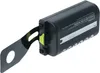 A black battery pack with a gray metal strap attached to the side, against a white background. Produktbild-Vorschau