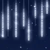 A dark blue background with several strings of white LED lights hanging down, resembling a meteor shower or icicle lights. Produktbild-Vorschau