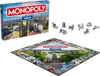 A Monopoly board game box and board with game pieces. Produktbild-Vorschau