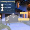 A person walking in front of a garage at night, illuminated by a floodlight. Produktbild-Vorschau