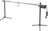 A stainless steel automatic rotisserie spit with a motor, mounted on two black tripod stands, against a white background. Náhľad obrázku produktu