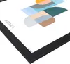 A close-up, angled view of a framed picture with abstract geometric shapes. Produktbild-Vorschau