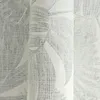 A close-up view of a rolled-up piece of wallpaper with a leaf pattern. Produktbild-Vorschau