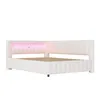 A white L-shaped bed frame with a pink LED light strip integrated into the headboard. Podgląd zdjęcia produktu