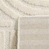 Close-up view of a cream-colored rug with a textured pattern and a beige backing. Podgląd zdjęcia produktu