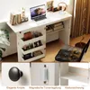 A white folding sewing table with storage shelves, a laptop, books, and headphones on top, and a black chair beside it. Close-up shots of the table's features are also shown. Náhľad obrázku produktu