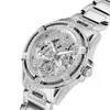 A close-up, angled view of a silver Guess watch with crystal embellishments. Voir les images du produit