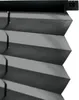 A close-up view of a black pleated blind, showing the texture and folds of the fabric. Produktbild-Vorschau