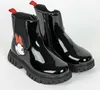 A pair of black patent leather boots with Minnie Mouse embellishments. Produktbild-Vorschau