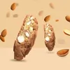 Almonds and biscotti are floating against a light brown background. Voir les images du produit