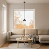 A modern living room with a sectional sofa, coffee table, and a large window overlooking autumn trees. Produktbild-Vorschau