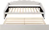 A white upholstered daybed with a pull-out trundle bed is shown from the front, with the trundle bed partially extended. Produktbild-Vorschau