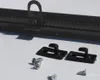A close-up shot of car accessories, including a black rear window roller blind mounting rail with a hook, two black mounting brackets, and three screws, laid out on a white surface. Podgląd zdjęcia produktu