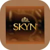 A square package for SKYN condoms with a brown textured border and a brown, wavy background. The brand name 'SKYN' is prominently displayed in gold lettering. Náhľad obrázku produktu