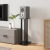 A living room scene with a speaker on a stand next to a TV stand and a cabinet. Anteprima dell’immagine prodotto
