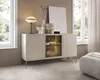 A modern sideboard in a well-lit room, styled with decorative objects and a lamp. Produktbild-Vorschau