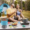 A couple is enjoying a meal outdoors in a forest setting, with camping gear visible. Produktbild-Vorschau