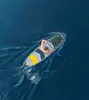 A person is paddleboarding on a body of water. Náhled obrázku produktu