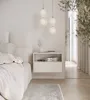A modern bedroom interior with a bedside table, bed, and hanging lights. Produktbild-Vorschau