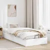 A white ottoman bed with a beige blanket and pillows, placed in a room with light beige curtains and a framed abstract artwork on the wall. Voir les images du produit