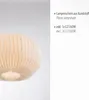 A close-up of a white, pleated lampshade hanging against a light gray and white background. Produktbild-Vorschau