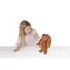 A young girl is interacting with a plush toy dog. Náhľad obrázku produktu