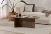 A living room scene with a couch, coffee table, plant, and rug. Anteprima dell’immagine prodotto