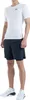 A man wearing a white t-shirt and dark shorts, posing for a product shot. Produktbild-Vorschau