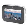 A digital camera is shown against a white background. The camera screen displays a cityscape. Podgląd zdjęcia produktu