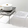 Two kitchen shelves are shown, one with a pot and induction cooker, and another empty shelf. Produktbild-Vorschau