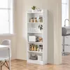 A white bookshelf filled with kitchen items and decor, placed in a room with a window and a table with a chair. Produktbild-Vorschau